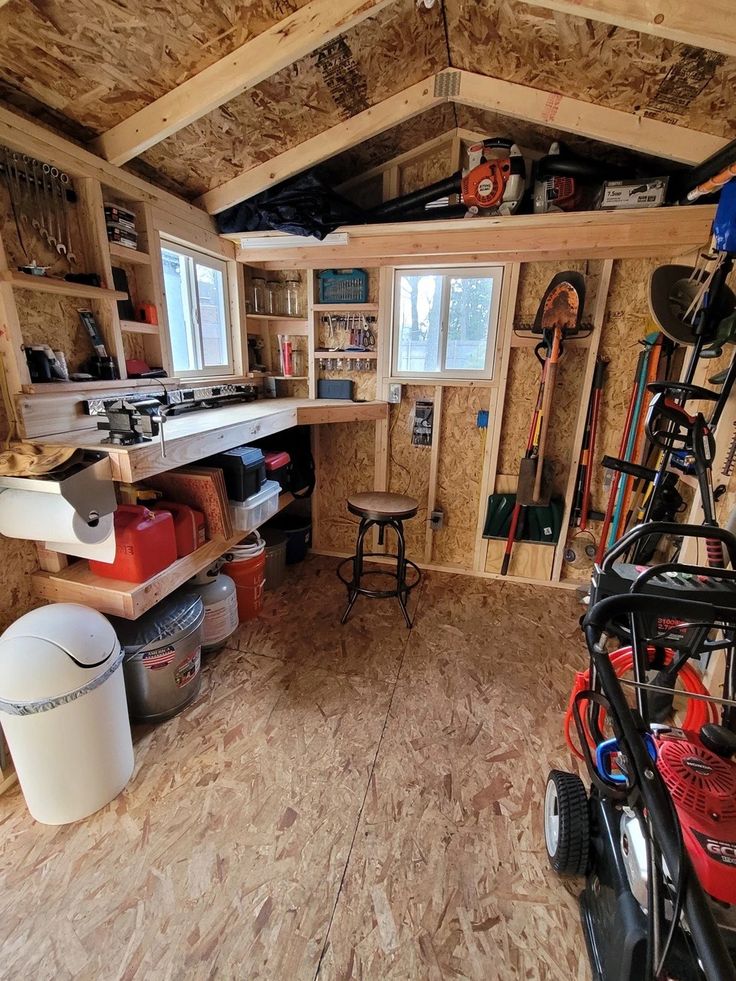 a garage with lots of tools and equipment in the storage area on top of it