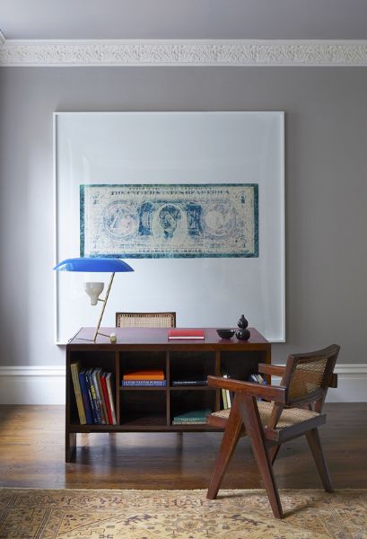 a wooden chair sitting next to a book shelf on top of a hard wood floor