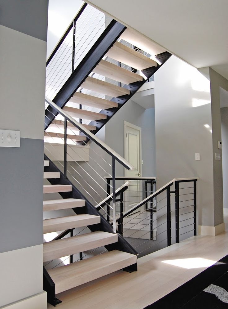 there is a set of stairs leading up to the second floor in this modern home