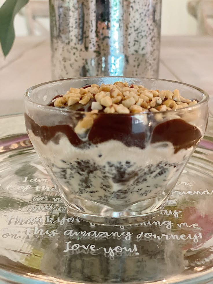 a glass bowl filled with food on top of a table