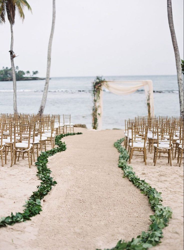 an outdoor ceremony setup on the beach