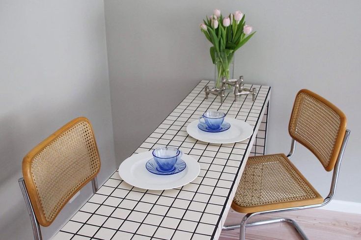 two chairs and a table with plates on it