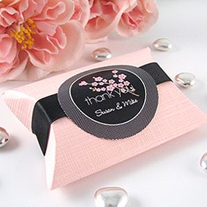 wedding packaging with pink flowers and pearls on the table in front of it is an advertise