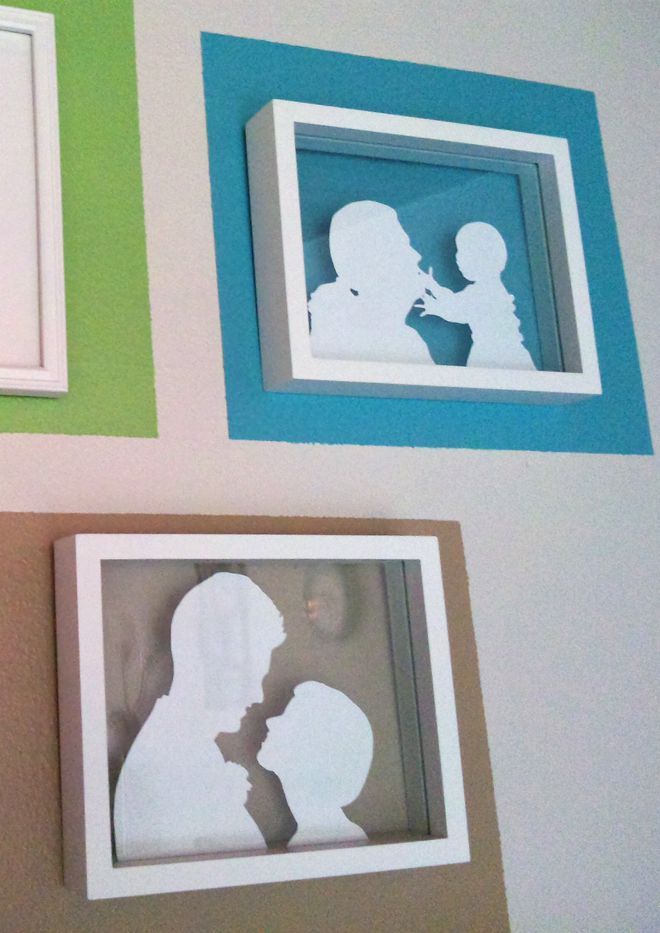 three framed silhouettes on the wall next to each other, one with a child's shadow