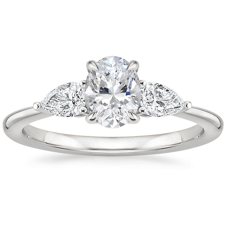 a white gold engagement ring with an oval cut diamond in the center and pave set shoulders