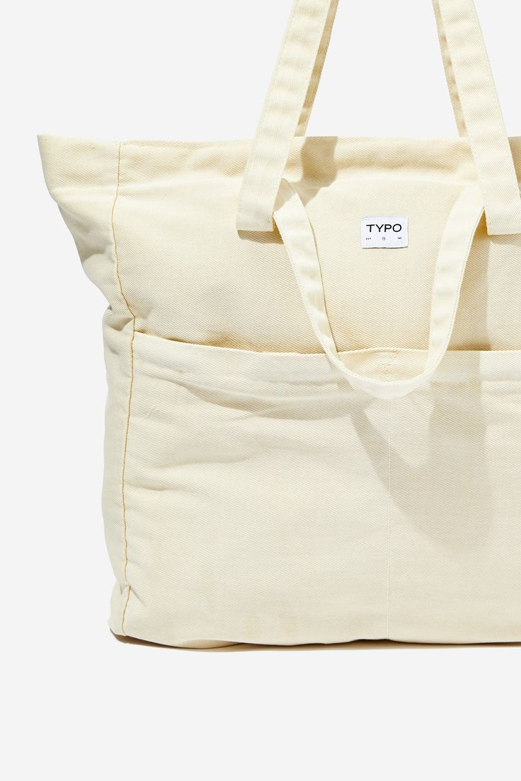 Wellness ToteTypo - Wellness Tote Bag - EcruTypo | Travel & Tech | Bags & TotesTypo | Travel & Tech | Bags & TotesTypo | Travel & Tech | Bags & Totes Beige Tote Shoulder Bag With Flat Pocket, Beige Everyday Bags With Flat Pocket, Beige Bags With Flat Pocket For Everyday Use, Everyday Beige Softback Canvas Bag, Trendy Cream Tote Beach Bag, Cream Shoulder Bag With Pockets For Everyday, Everyday Cream Shoulder Bag With Pockets, Everyday Beige Canvas Bag With Flat Pocket, Beige Travel Bags With Flat Pocket