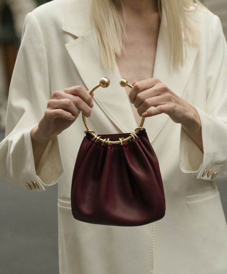 Details Charming and versatile, this Ring Handle Bag can be styled for your perfect evening dinner outfit! No matter the style of wear, the soft leather is a bronze example of quality. Size: Length: 21 cm Height: 17 cm Handle Diameter: 11.5cm Weight: 200g Shipping & Return Free US shipping on orders over $100.Free International shipping on orders over $300. For more details click HERE. Gold Leather Handheld Evening Bag, Chic Gold Clutch With Metal Hardware, Elegant Formal Clutch With Round Handle, Elegant Clutch With Round Handle For Formal Occasions, Elegant Evening Clutch With Round Handle, Chic Formal Evening Bag With Round Handle, Gold Evening Bag With Metal Hardware, Elegant Leather Clutch With Round Handle, Formal Clutch With Detachable Strap And Round Handle