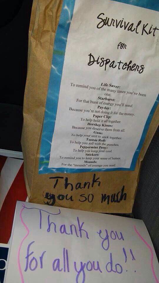 a brown paper bag sitting on top of a table next to a thank you for all you do sign