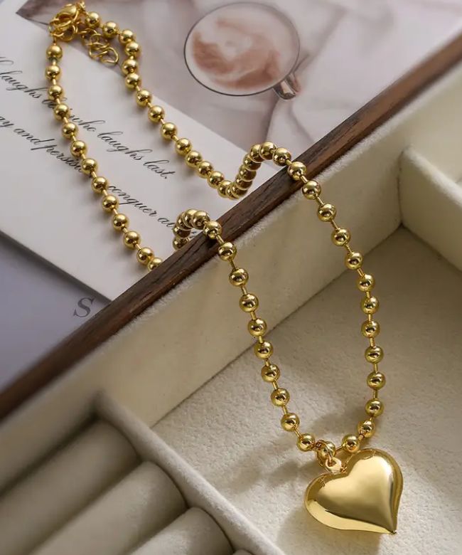 Experience the ultimate expression of love with the Gold Beaded Heart necklace! Crafted with luxurious gold beads, this necklace will add a touch of elegance to any outfit. Perfect for special occasions or daily wear, it's a beautiful reminder of the precious bond between loved ones. Spark joy and ignite passion with this stunning accessory. Gold filled Heart charm: 2.8cm x 2.2cm Length: 40cm Heart Shaped Ball Chain Necklace For Gift, Heart-shaped Ball Chain Necklace Gift, Valentine's Day Gift Ball Chain Necklace, Gold Necklaces With Heart Charm And Round Beads, Heart Shaped Ball Chain Necklace For Valentine's Day, Heart-shaped Ball Chain Necklace For Valentine's Day, Gold Heart-shaped Beaded Necklaces, Heart-shaped Beaded Clavicle Chain Necklace For Gift, Heart-shaped Beaded Clavicle Necklace As Gift