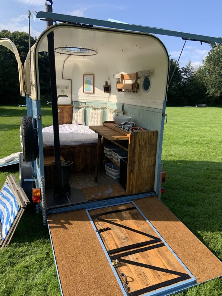 the inside of a trailer is shown with its door open and bed on it's side