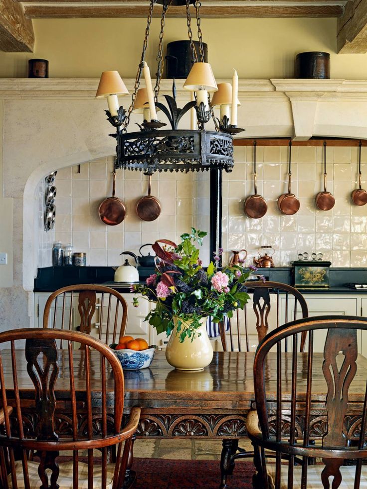 a dining room table with chairs and a potted plant on top of the table