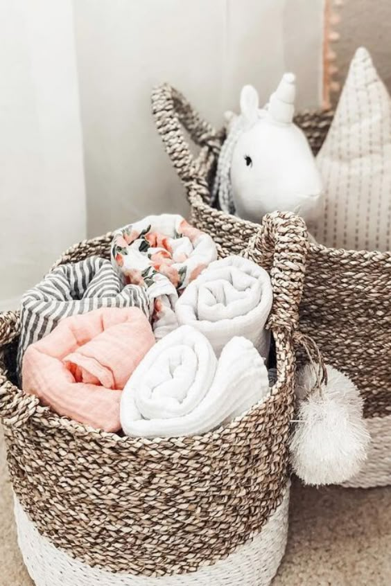 two baskets filled with blankets and stuffed animals