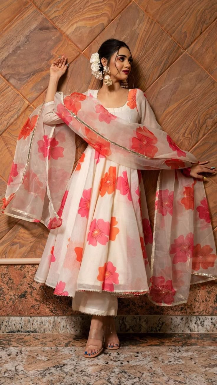 PRODUCT DESCRIPTION: Anarkali : Chanderi Pant: Cotton silk Dupatta: Organza Color: off white with orange and pink printed flowers. work : Gotta lace work, stone work embellishment all over dupatta No. Of Components : Set of 3 Wash Care : Dry Clean Customization : Only Size and Length Of Product SKU#: 11403219WH Disclaimer: All our pieces are handcrafted in our manufacturing unit .We Ensure that our pieces are shot professionally under controlled lighting. Colours tend to be perceived differently Printed Anarkali Suits, Floral Anarkali, Anarkali Dress Pattern, Traditional Indian Dress, Salwar Kamiz, Indian Dresses Traditional, Traditional Indian Outfits, Kurti Designs Party Wear, Indian Gowns