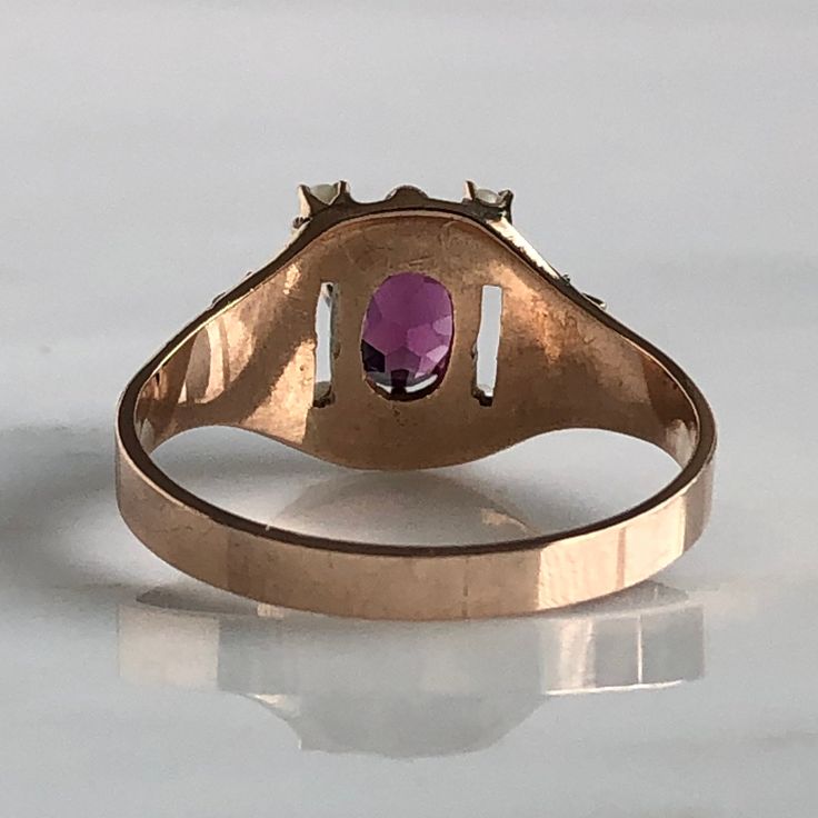 Details: Beautiful Victorian Garnet and Seed Pearl ring set in lovely 14K rose gold. The band is adorned in lovely abstract filigree engraving. The stone has great depth, and has a lovely rich pink tint to the garnet. It is surrounded by 4 seed pearls. The garnet measures 7.5mm x 5mm. There are no internal markings. Measurements: Ring measures a size 7 3/4 US. It can be re-sized for a fee. Condition: The overall all condition of this ring is very good. Please ask all questions prior to placing a Vintage 14k Gold Ruby Ring With Accent Stones, Pink Ruby Ring Stamped 14k For Wedding, Pink Rings With Intricate Design For Anniversary, Heirloom Rose Gold Ruby Promise Ring, Oval Rose Gold Ruby Ring With Rose Cut Diamonds, Oval Pink Gold Ruby Ring For Wedding, Pink 14k Stamped Fine Jewelry Rings, Pink 14k Stamped Promise Ring, Vintage 14k Rose Gold Rings