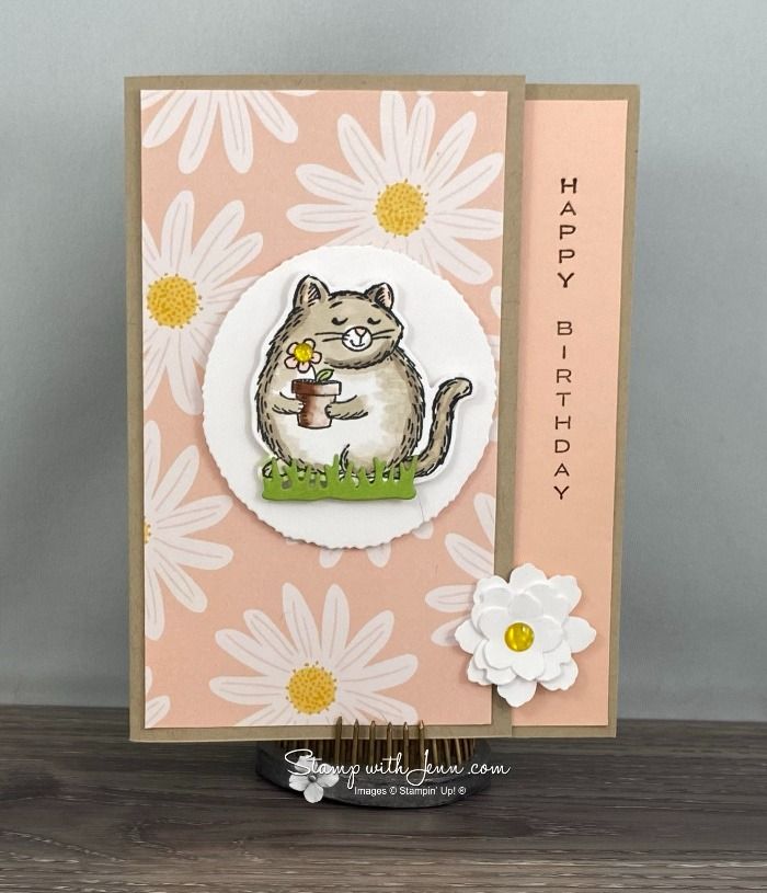 a card with a cat holding a flower