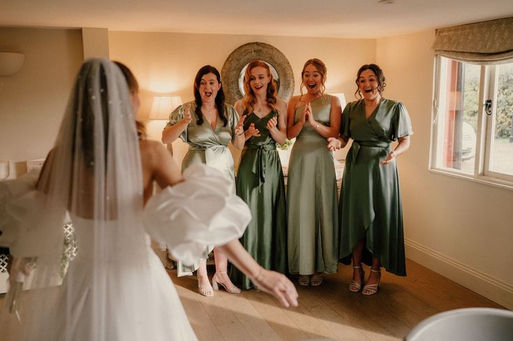 the bride and her bridesmaids are getting ready to go into their wedding ceremony