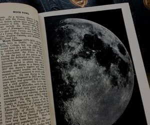 an open book with pictures of the moon