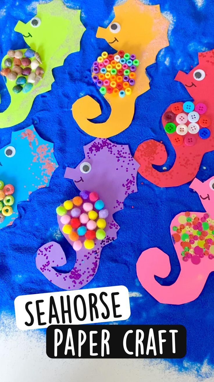 seahorse paper craft for kids with buttons and beads on the ocean floor next to it