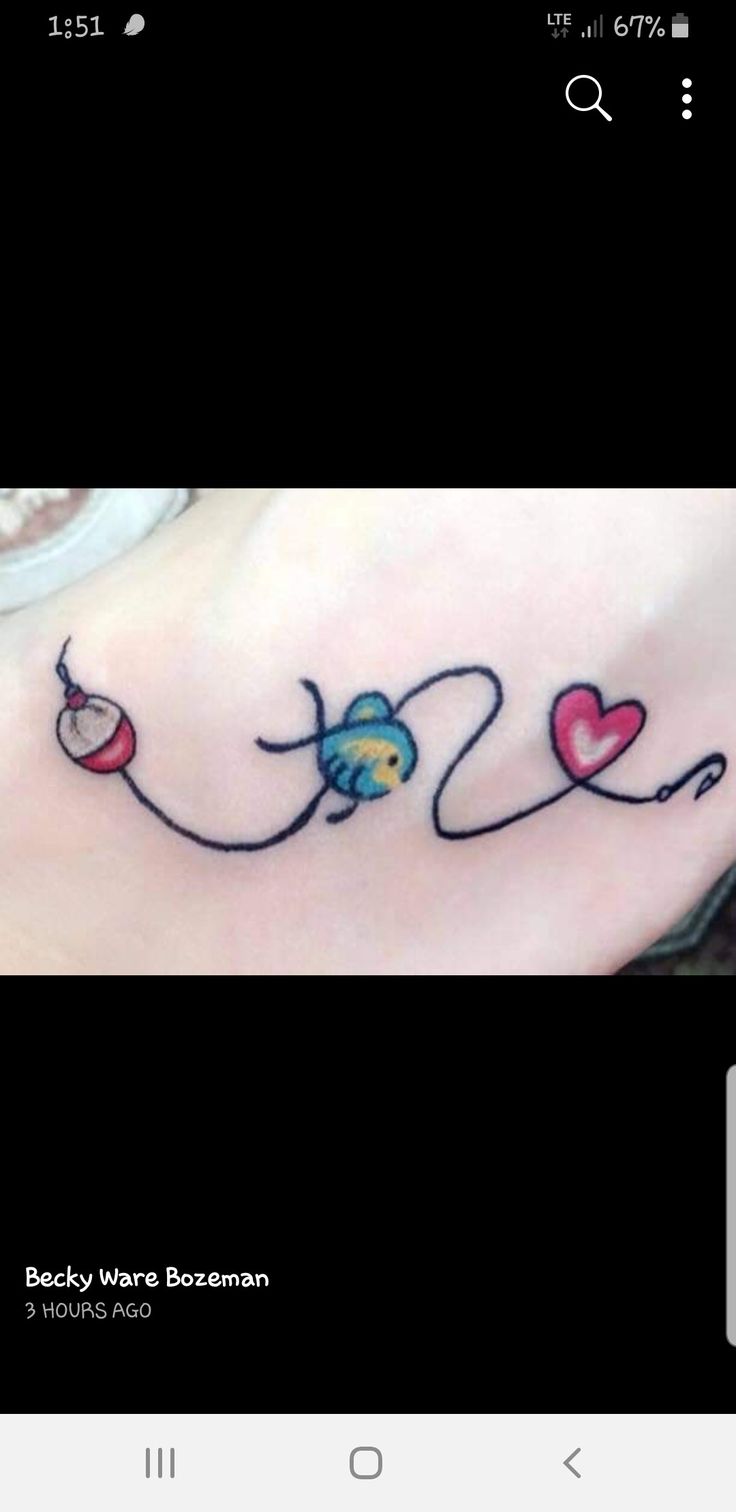 a small tattoo on the side of a woman's foot, with hearts and an arrow