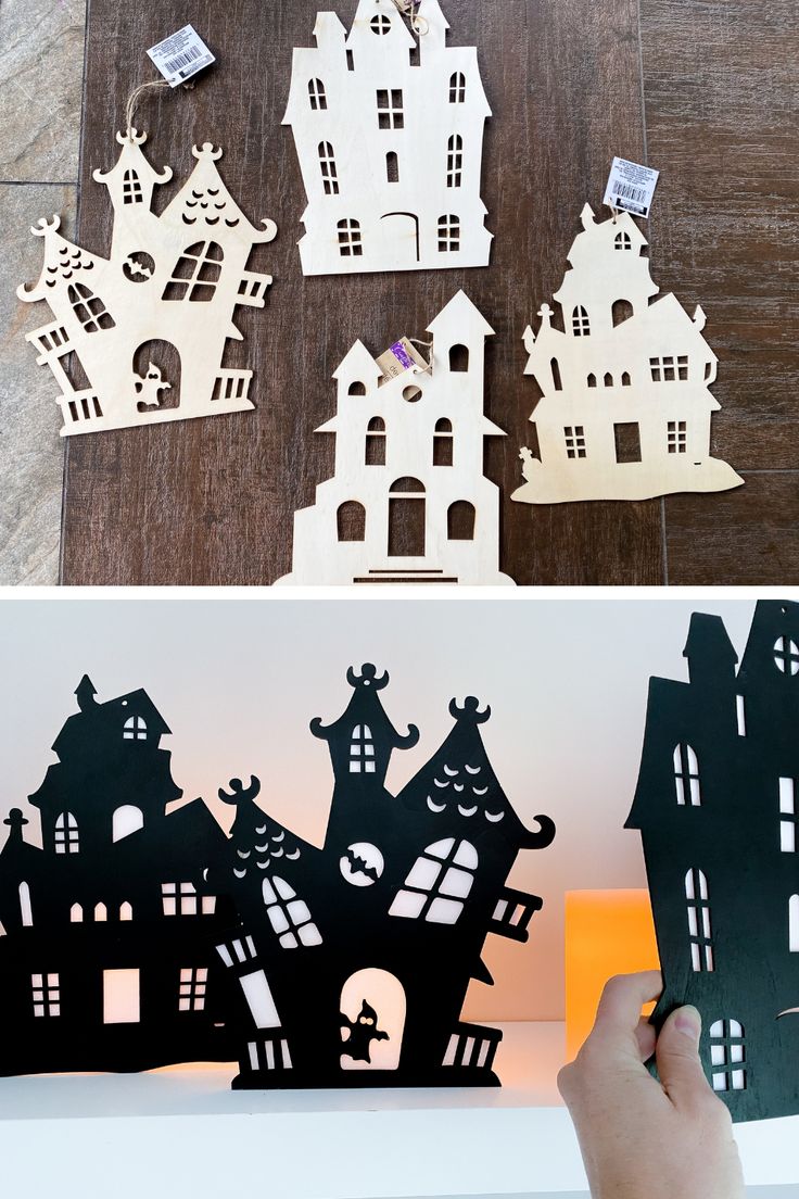 someone is holding up some cut out paper houses