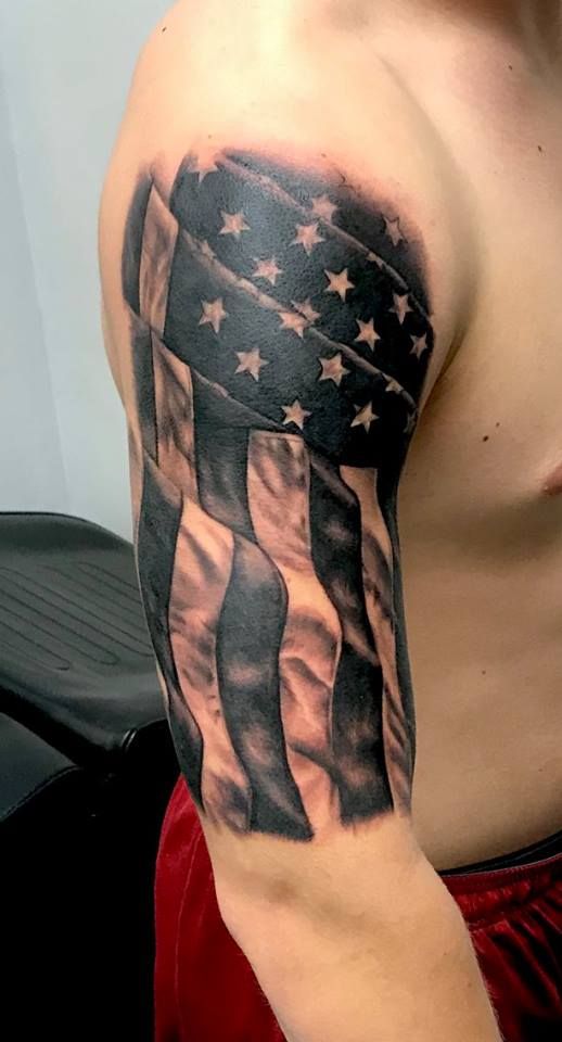 a man's arm with an american flag tattoo on it