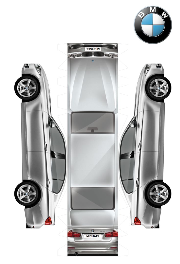 the rear view of a silver car with its doors open and two wheels in front