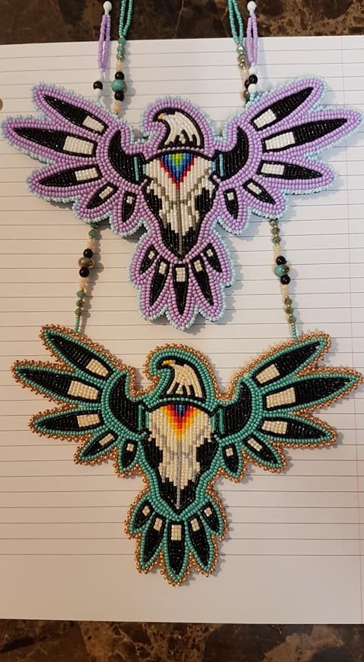 two beaded necklaces on top of a piece of paper next to each other