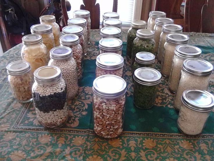 there are many jars with different types of food in them on the table next to each other