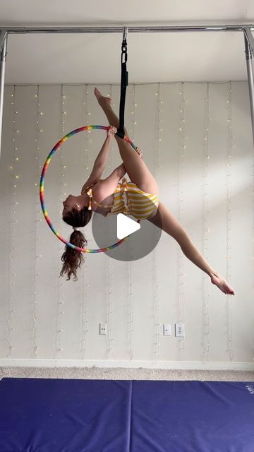 a girl doing aerial acrobatics on a hoop