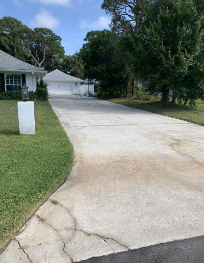 an empty driveway in front of a house