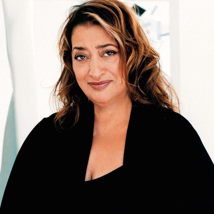 a close up of a person wearing a black shirt and smiling at the camera with her hair blowing in the wind