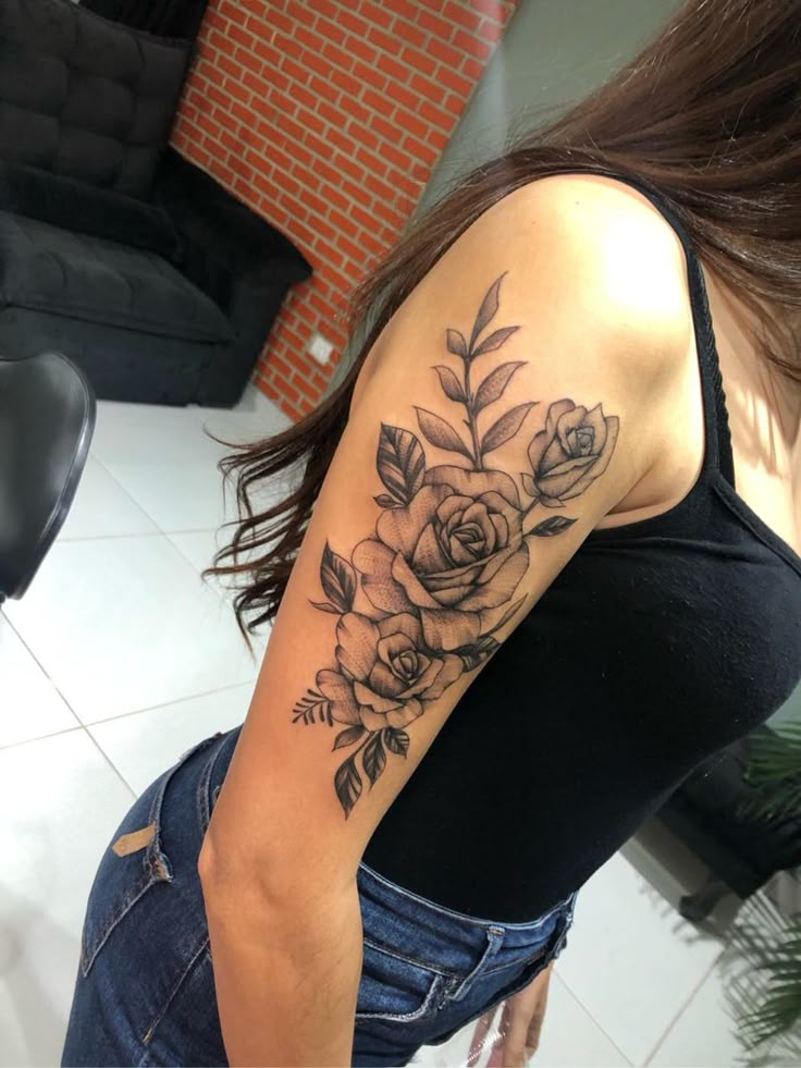 a woman with a flower tattoo on her arm