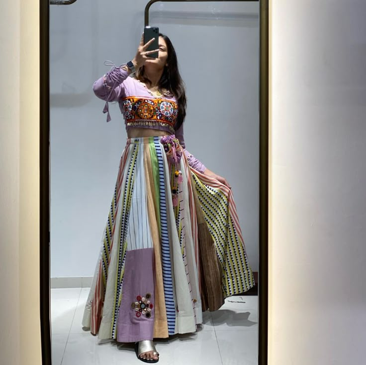 a woman taking a selfie with her cell phone in front of a display case