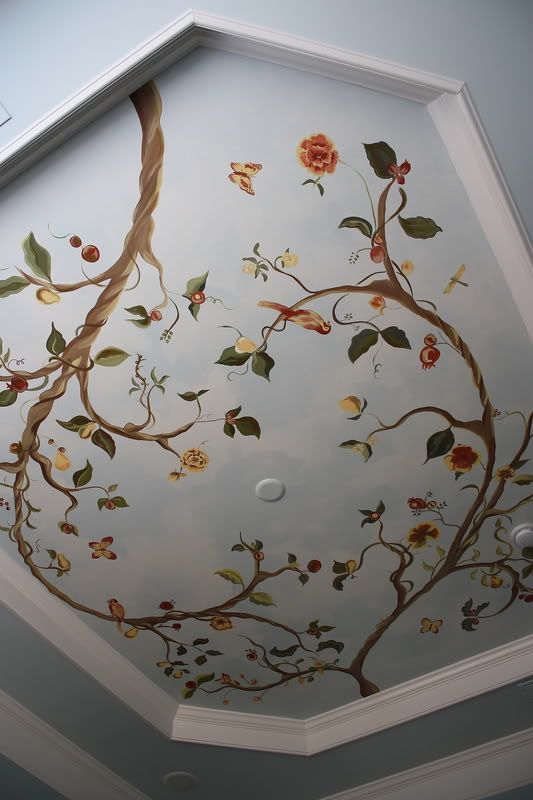 a painted ceiling with flowers and leaves on the ceiling is shown in this room,