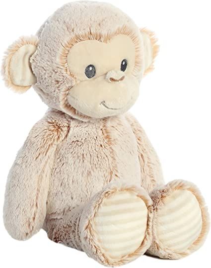 a stuffed monkey sitting on the ground