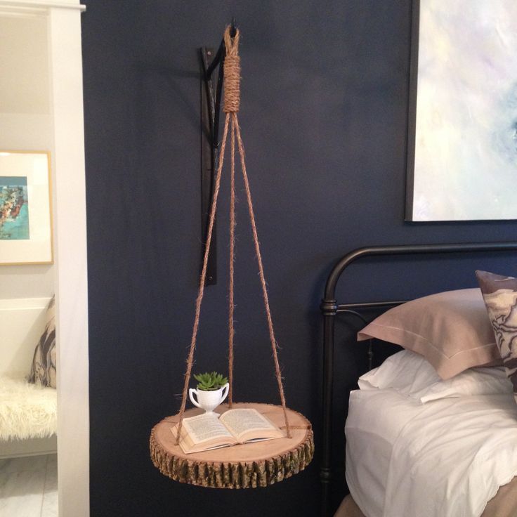 a bed room with a bed and a hanging planter