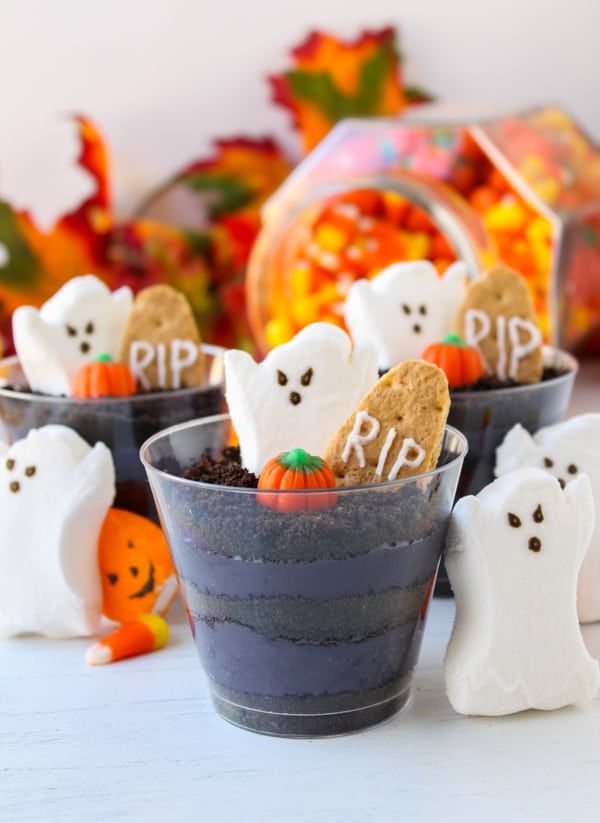 halloween treats in small cups with ghost cookies