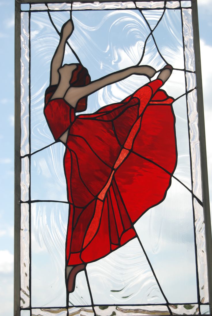 a stained glass window with a ballerina in red dress on it's side