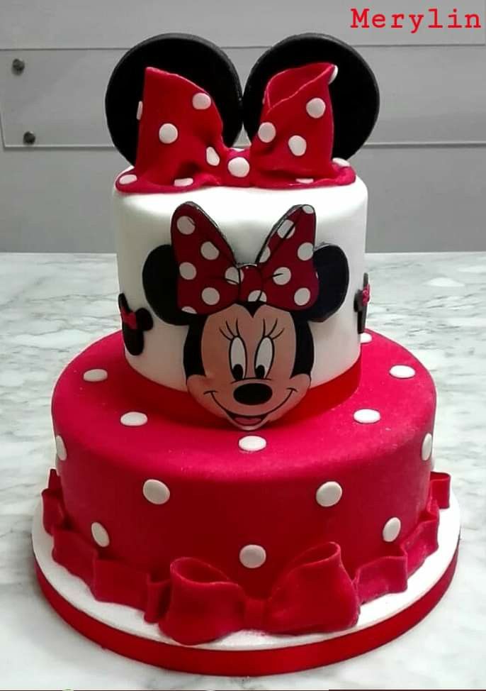 a red and white cake with minnie mouse on top