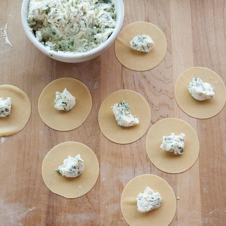 several small plates with food on them next to a bowl of dip and crackers