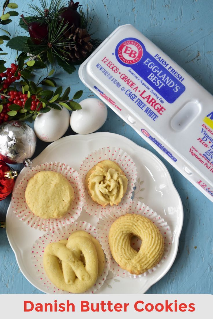 danish butter cookies on a plate next to an egg carton