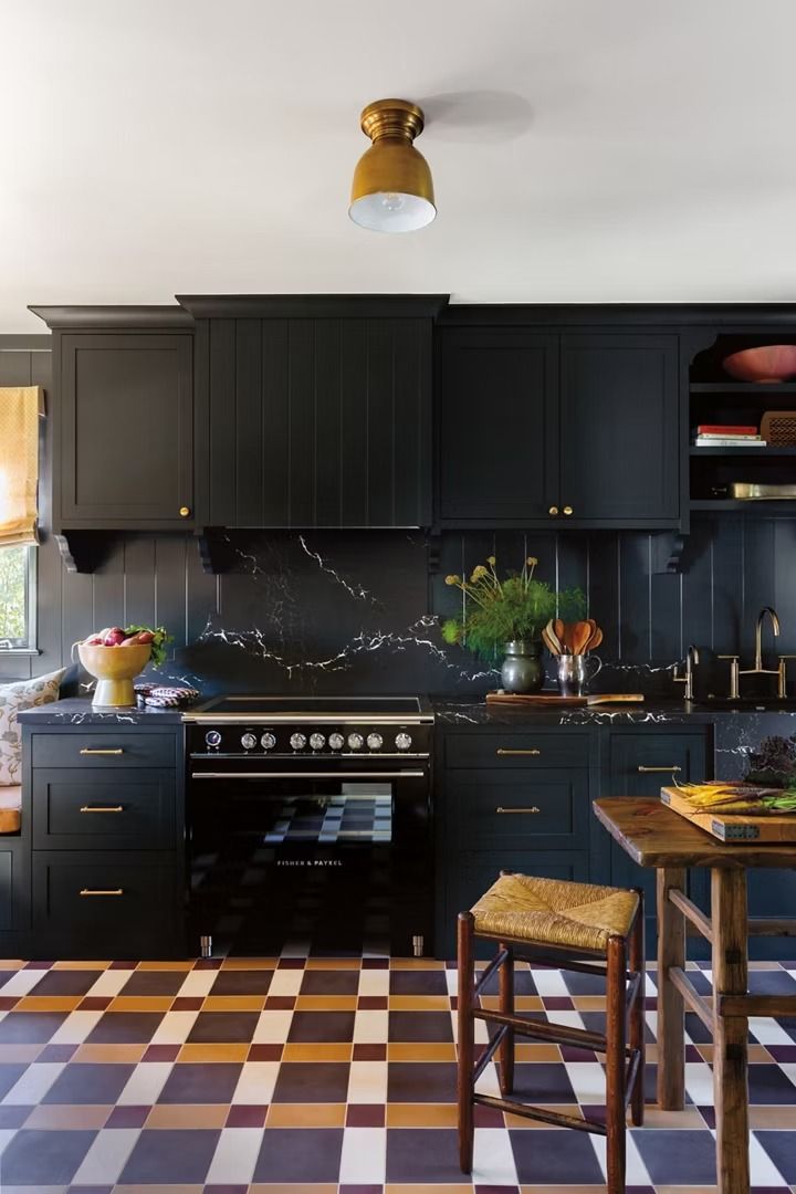 a kitchen with black cabinets and checkered flooring on the floor is pictured in this image