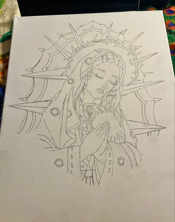 a drawing of the virgin mary on paper