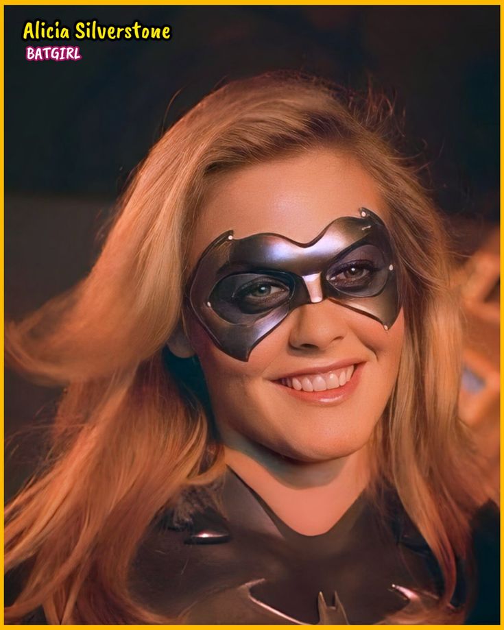 a woman wearing a catwoman mask and black leather outfit with yellow frame around her eyes