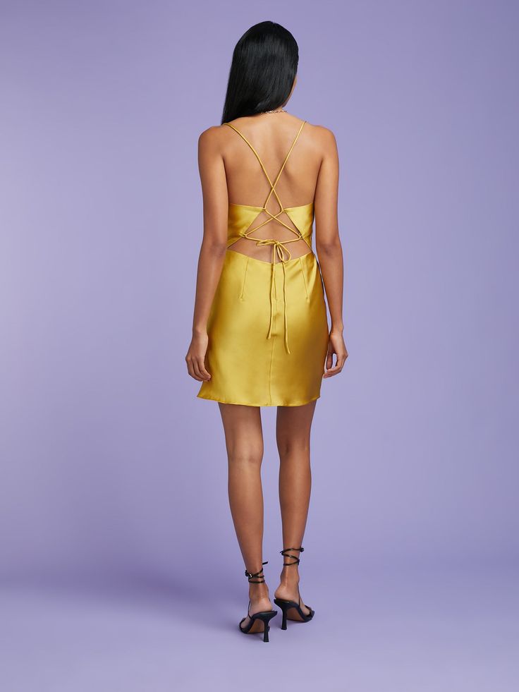 Meet the Riviera's Mini Me; cut for a micro length in a shade of golden green, this 90s-inspired number is ready to *literally* reach new heights of sexy. Featuring the same iconic lace up back as the Riviera Midi in the same slinky deadstock fabric, we love the Riviera's versatility teamed with boots for a laidback festival look or dressed up with colour-pop sandals when evening cocktails call. Golden Green, Evening Cocktail, 90s Inspired, Polyester Satin, Festival Looks, Mini Me, Cowl Neck, Satin Fabric, Lace Dress