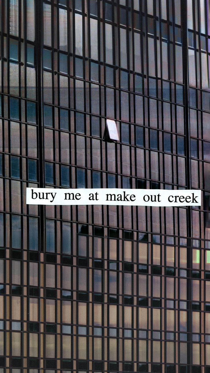 a sign on the side of a building that says, buy me at make out creek