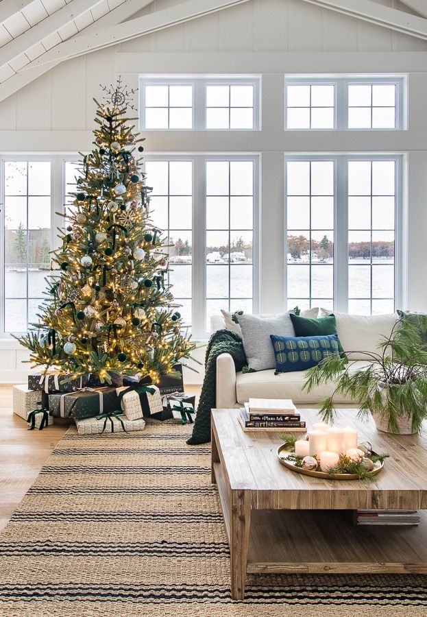 a living room filled with furniture and a christmas tree in the middle of the room