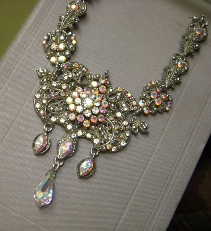 "Absolutely stunning vintage aurora borealis rhinestone necklace! Not enough adjectives to describe this decadent, sparkling necklace.  Loaded with aurora borealis rhinestones in a very ornate design.  My photos describe it best. Not signed.  Circa-50's or 60's.  Silvertone with hinged, fold-over clasp.  Measures approx. 16.5\".  No loose or missing rhinestones. Perfect for a wedding, anniversary, or special night out.  This looks like something worn by royalty!  Definitely the prettiest rhinest Evening Necklace, Vintage Rhinestone Necklace, Ornate Design, Sparkle Necklace, Rhinestone Necklace, Not Enough, Vintage Rhinestone, Aurora Borealis, Crystal Necklace