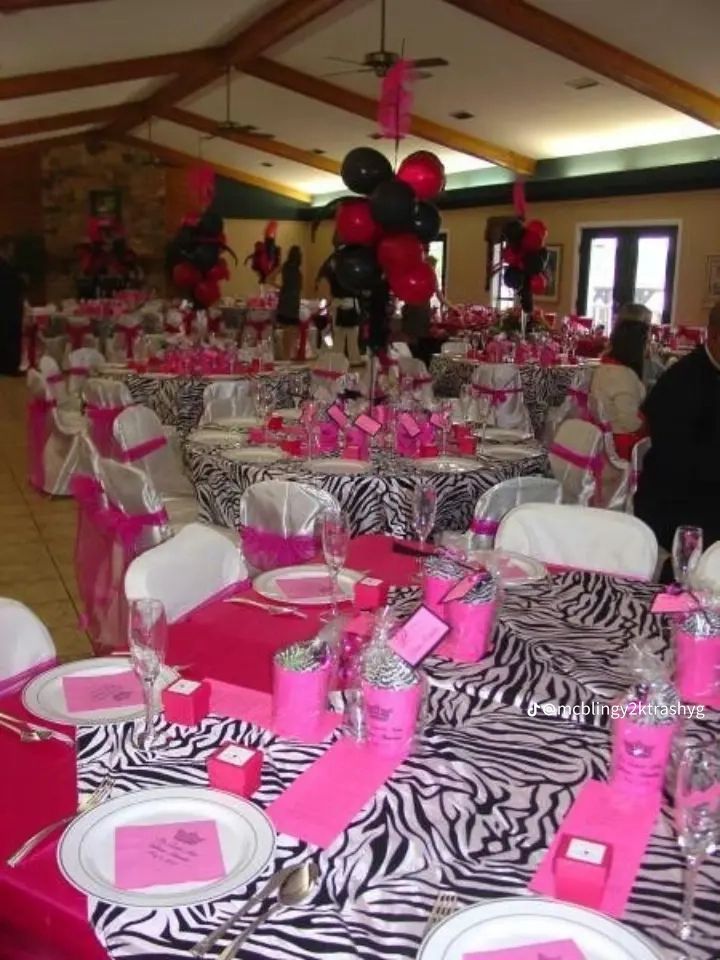 the tables are decorated with zebra print and pink napkins