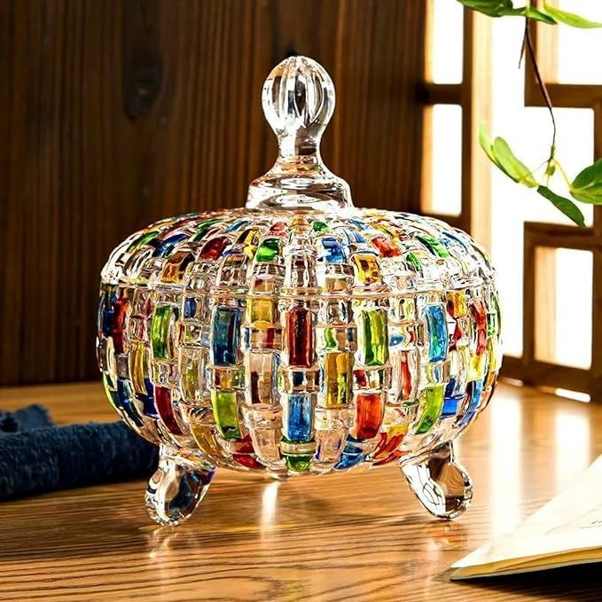 a colorful glass jar sitting on top of a wooden table